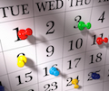 Close up , colorful pushpins on calendar