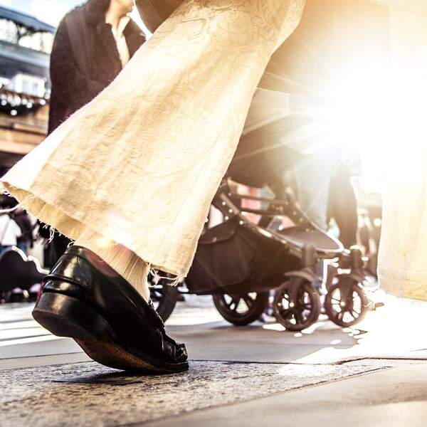 Anonymous crowd of people walking on busy city street - City life concept